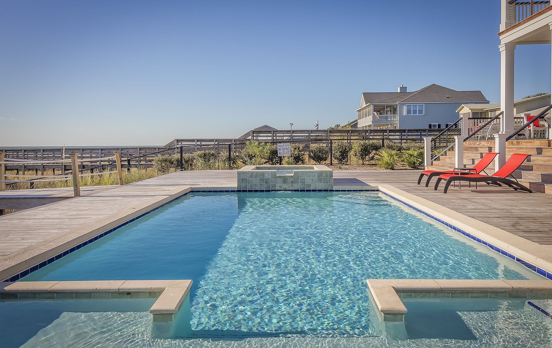A sparkling backyard pool with loungers on the Mississippi Gulf Coast